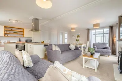 a living room with two couches and a kitchen at 3 Bed in Padstow oc-l33613 in Padstow