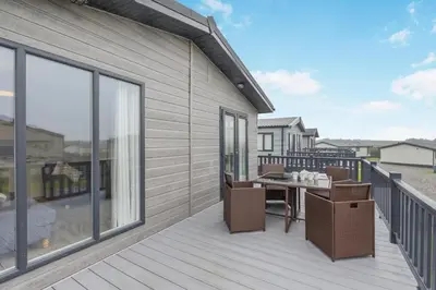 a patio with a table and chairs on a balcony at 3 Bed in Padstow oc-l33613 in Padstow