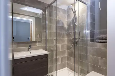 a bathroom with a shower and a sink at Crystal View, Compass Point - Sea View - Free WiFi & Parking - Close to Beach in Carbis Bay