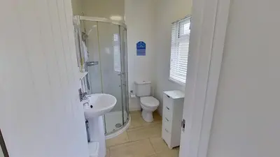 a bathroom with a shower and a toilet and a sink at G24 Trelinda, Riviere Towans in Hayle