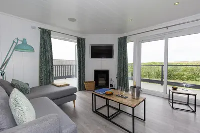 a living room with a couch and a table at Dahlia in Redruth
