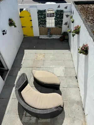 a couple of chairs sitting on a patio at Num 29 in Newquay