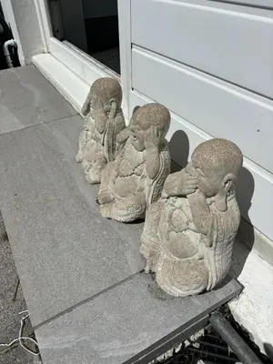 a group of stone birds sitting next to a door at Num 29 in Newquay