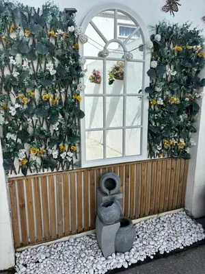 a building with a wall of flowers and a window at Num 29 in Newquay