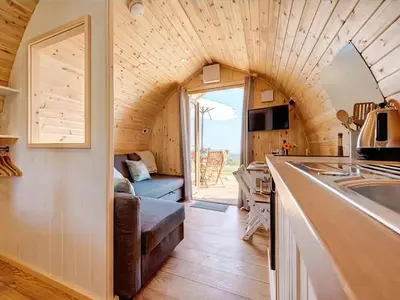a tiny house with a kitchen and a living room at Scenic Bay in Penzance