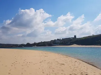 a sandy beach with a view of the ocean at Scenic Bay in Penzance