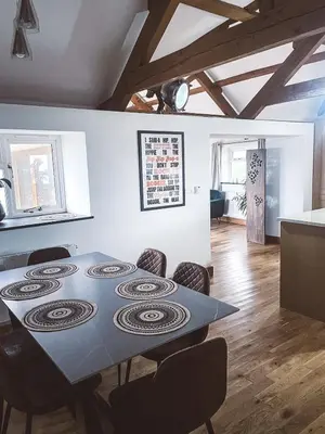 a dining room with a table and chairs at The Retreat Cornwall holiday home with hot tub in Crowan