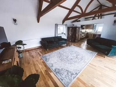 a living room with a couch and a rug at The Retreat Cornwall holiday home with hot tub in Crowan