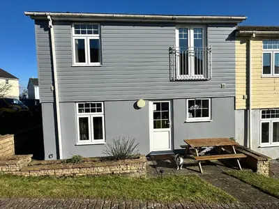 a house with a picnic table in front of it at Dog Friendly Holiday Home in Newquay Cornwall in Newquay