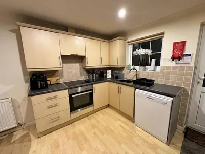 a kitchen with white cabinets and a counter top at Dog Friendly Holiday Home in Newquay Cornwall in Newquay