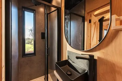 a bathroom with a sink and a mirror at Cabins at Bogee Farm in Saint Ervan