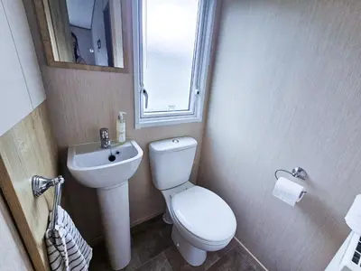 a small bathroom with a toilet and a sink at Cornish Dream in Truro