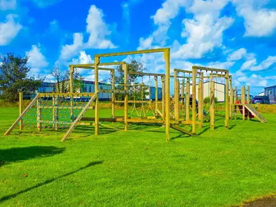 a row of empty playground equipment in a field at Cornish Dream in Truro