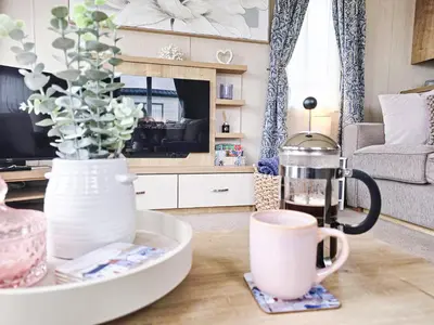 a living room with a coffee table with a coffee maker at Cornish Dream in Truro