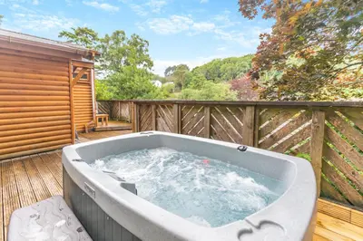 a large bath tub sitting on a deck at Landal Leycroft Valley in Perranzabuloe
