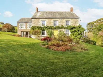 an old stone house with a large yard at Tresarrett Manor in Bodmin