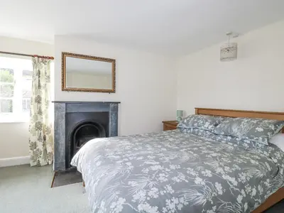 a bedroom with a bed and a fireplace at Tresarrett Manor in Bodmin