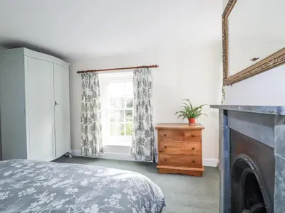 a bedroom with a bed and a window at Tresarrett Manor in Bodmin