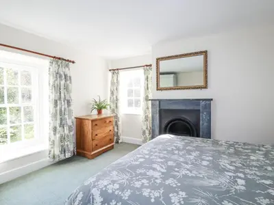a bedroom with a bed and a fireplace at Tresarrett Manor in Bodmin