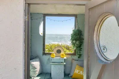 a window in a room with a view of the ocean at Lightkeepers Cottage in Charlestown