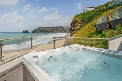 a bath tub with a view of the beach at The Tide House in Portreath