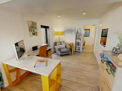 a living room with a desk and a couch at The Tide House in Portreath