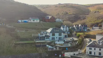 a group of houses on a hill with mountains at The Tide House in Portreath