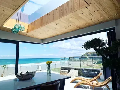 a dining room with a view of the ocean at The Tide House in Portreath