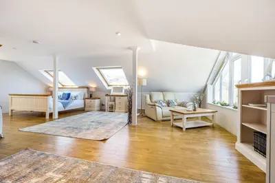 a living room with a couch and a table at Tranquil Shores in Carbis Bay
