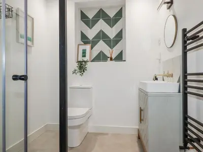 a bathroom with a toilet and a sink at Teach Tra East in Perranporth