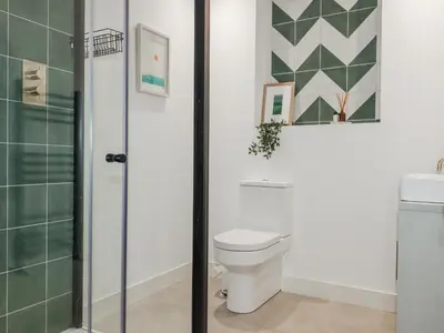 a bathroom with a toilet and a sink at Teach Tra East in Perranporth
