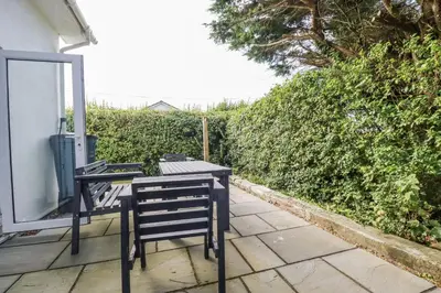 a table and chairs sitting on a patio at Hilbre in Padstow