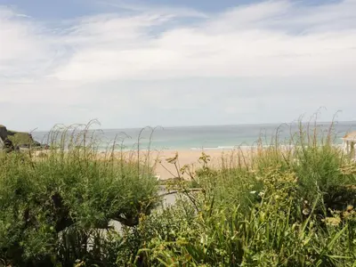 a beach with the ocean in the background at Hilbre Shepherd Hut in Padstow