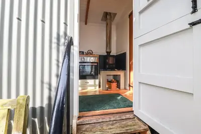 a hallway with a door leading to a living room at Hilbre Shepherd Hut in Padstow