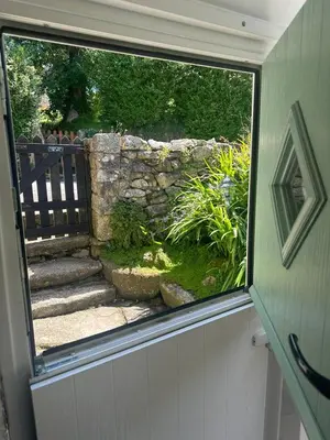a view of a garden from the outside of a window at Klys cottage in Saint Breward