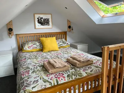 a bedroom with a bed with two towels on it at Little Tregue in Camelford