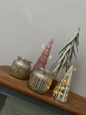 three metal vases on a shelf with a christmas ornament at Little Tregue in Camelford