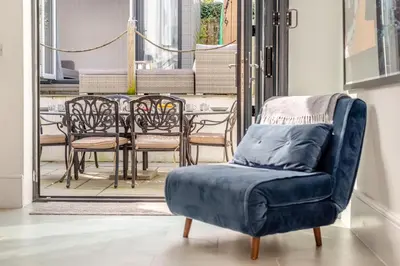 a blue chair in a room with a table and chairs at 3 Bed in Padstow oc-f33036 in Padstow