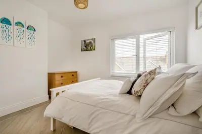a white bedroom with a large white bed with pillows at 3 Bed in Padstow oc-f33036 in Padstow