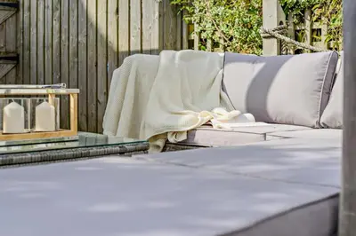 a blanket sitting on a couch on a patio at 3 Bed in Padstow oc-f33036 in Padstow