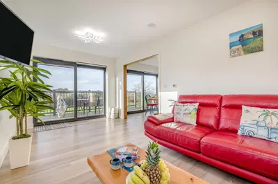 a living room with a red couch and a table at 2 Bed in Crackington Haven oc-h33817 in Crackington Haven