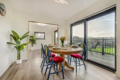 a dining room with a table and chairs and a large window at 2 Bed in Crackington Haven oc-h33817 in Crackington Haven
