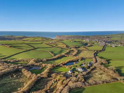 an aerial view of a field with the ocean at 2 Bed in Crackington Haven oc-h33817 in Crackington Haven