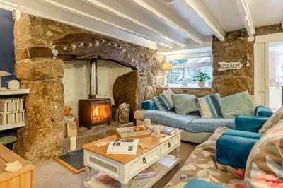 a living room with a couch and a stone fireplace at 2 Bed in St. Ives oc-g33644 in St Ives