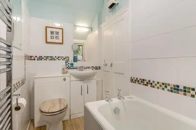a bathroom with a tub and a toilet and a sink at 2 Bed in St. Ives oc-g33644 in St Ives