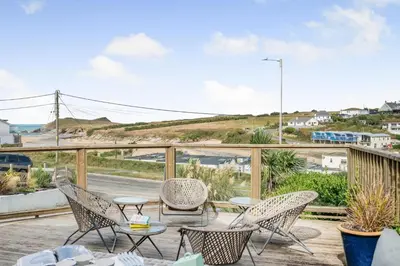 a patio with chairs and tables on a balcony at 5 Bed in Newquay oc-c33035 in Newquay