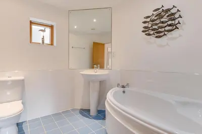 a bathroom with a tub and a sink and a toilet at 2 Bed in Porthleven oc-p00890 in Porthleven