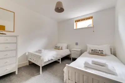 a bedroom with two beds and a dresser at 2 Bed in Porthleven oc-p00890 in Porthleven