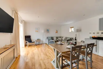 a kitchen and living room with a table and chairs at 2 Bed in Porthleven oc-p00890 in Porthleven