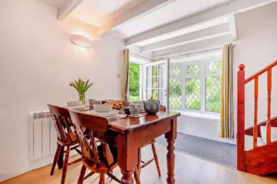 a dining room with a wooden table and chairs at 2 Bed in Advent oc-s6025 in Camelford